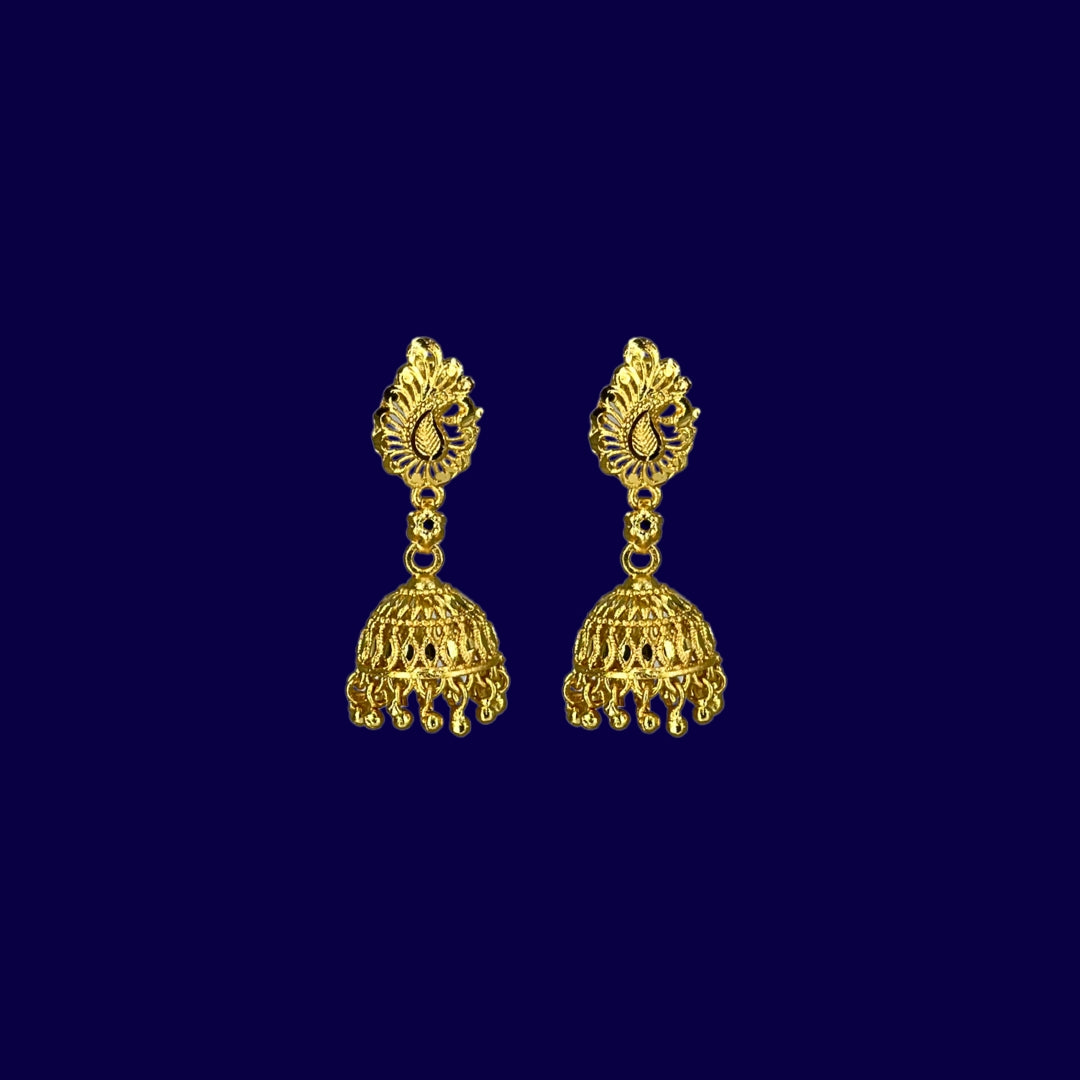 Pair of Nira Kalyani gold plated jhumka earrings on a dark blue background